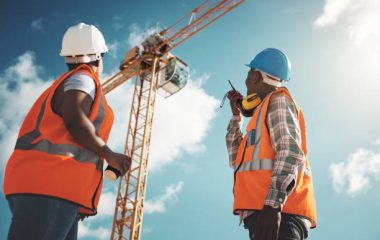 Shot of a young man and woman working with a crane at a construction site