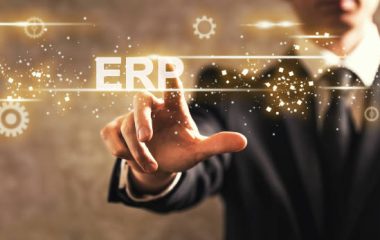 ERP text with businessman on dark vintage background