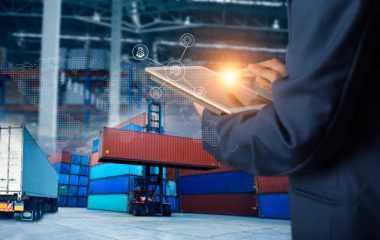 Businessman manager using laptop check orders online goods worldwide for network with Modern Trade warehouse logistics. Industry of logistics network concept.