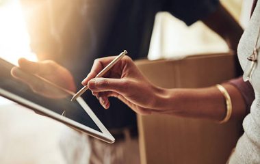 High angle shot of an unrecognizable woman signing for a home delivery