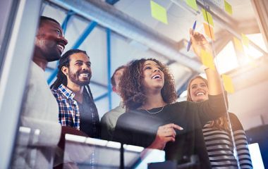 Shot of colleagues having a brainstorming session with sticky notes at work