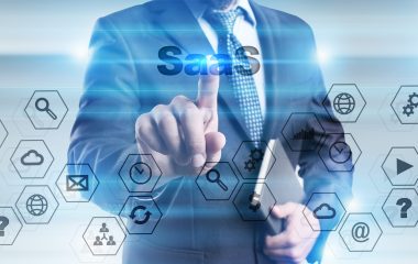 Businessman is pressing button on touch screen interface and selecting "SaaS".