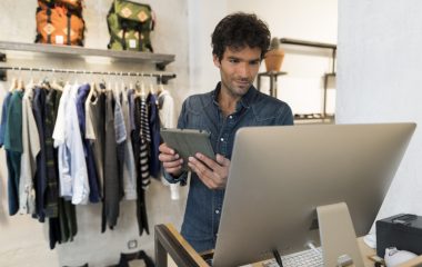 Man manager of Fashion Store with digital tablet and computer pc